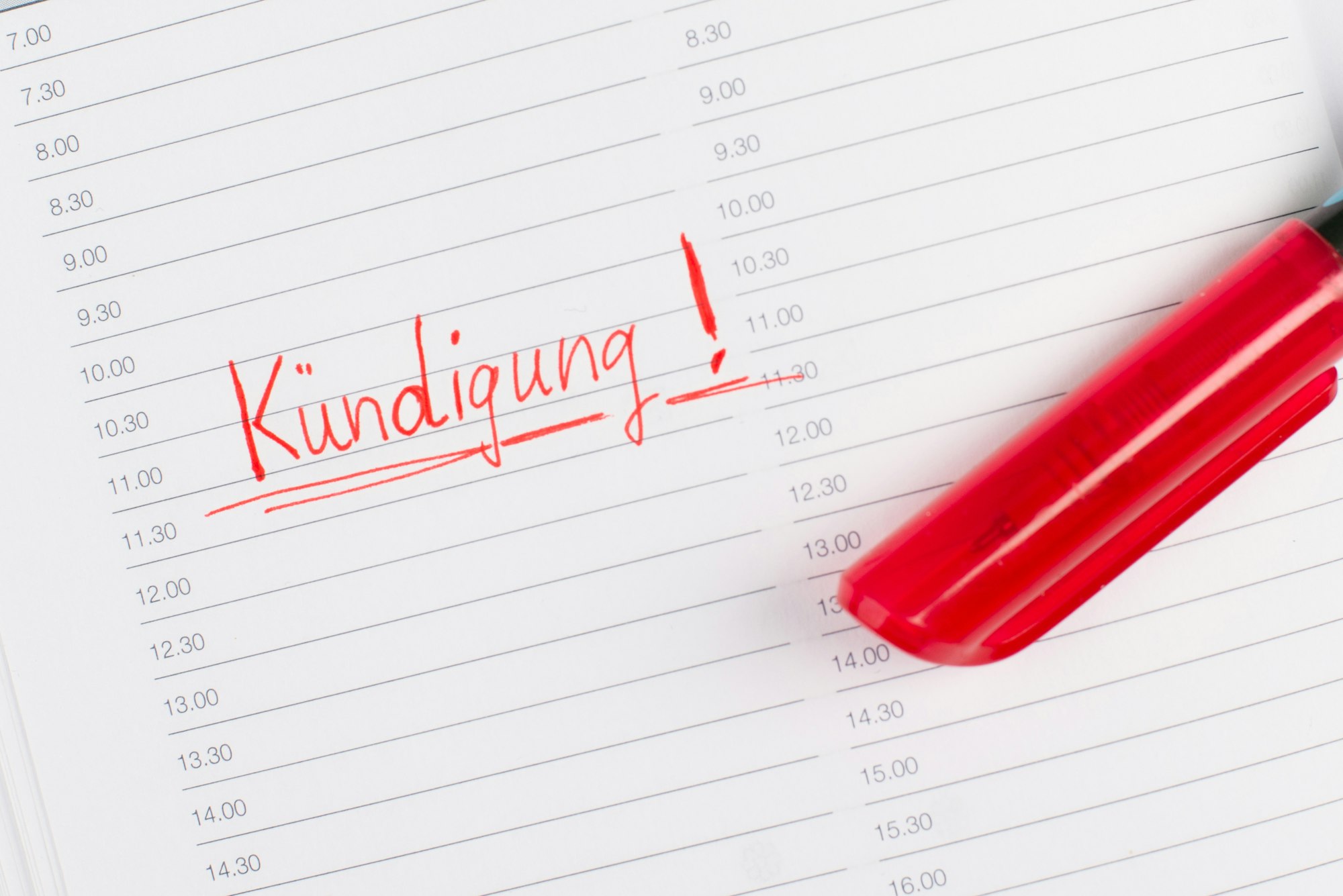 Termination is standing in german language in a calendar, red color and pen, fired from job