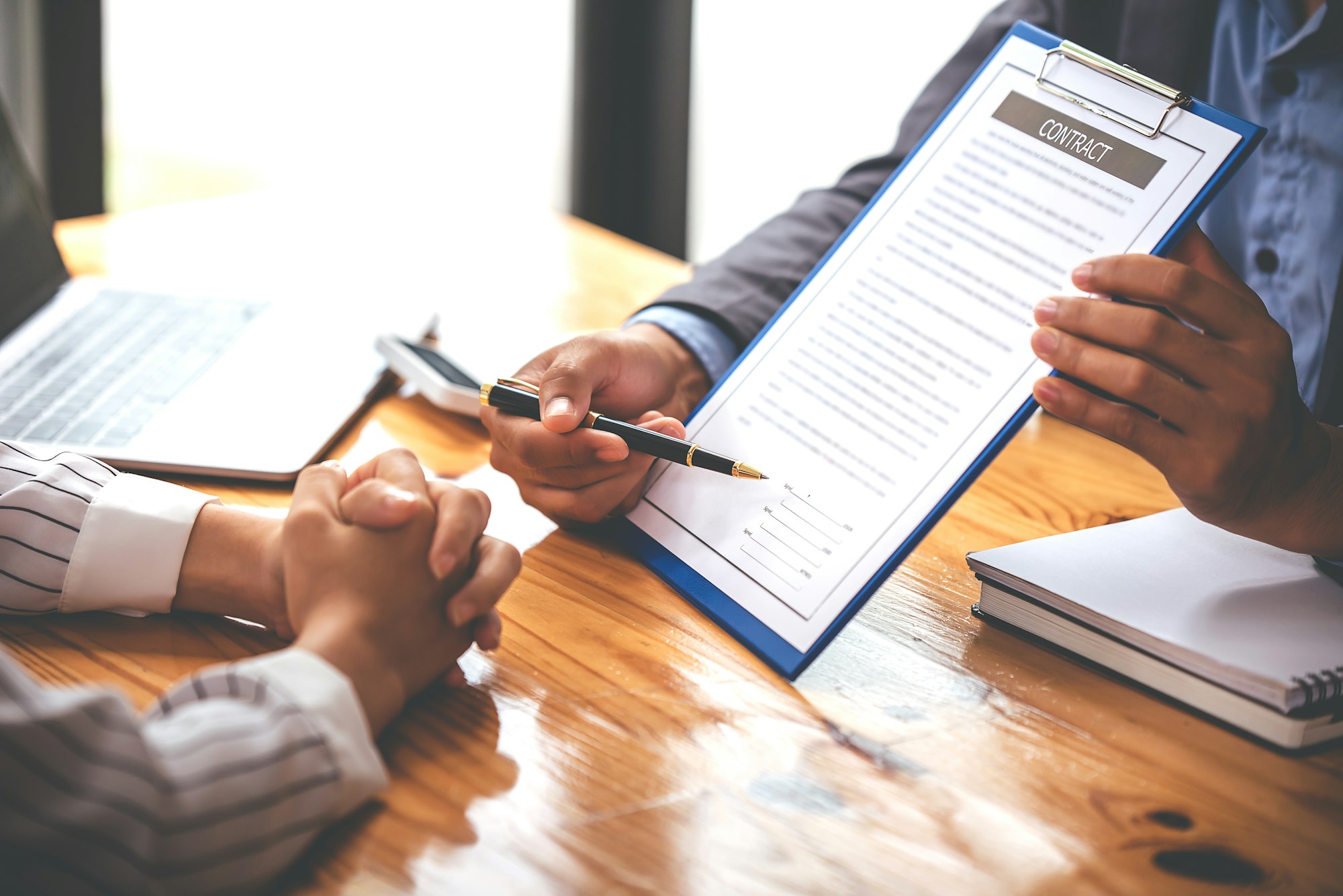 business people negotiating contracts with the documents on the table and sign the contract